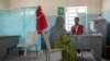 FILE - A Tigrayan woman who says she was gang raped by Amhara fighters, speaks to surgeon and doctor-turned-refugee, Dr. Tewodros Tefera, at the Sudanese Red Crescent clinic in Hamdayet near the Sudan-Ethiopia border, eastern Sudan, March 23, 2021. 