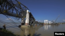 The Radana Thinga Bridge over the Irrawaddy River, still under construction, collapses following an earthquake near Singgu Township in central Burma, November 11, 2012.