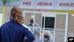 Amid concerns of the spread of COVID-19, census worker Ken Leonard wears a mask as he mans a U.S. Census walk-up counting site set up for Hunt County in Greenville, Texas, July 31, 2020.
