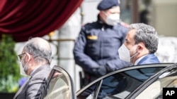 Political deputy at the Ministry of Foreign Affairs of Iran, Abbas Araghchi, right, arrives at the Grand Hotel Wien where closed-door nuclear talks with Iran take place in Vienna, Austria, Tuesday, April 6, 2021. (AP Photo/Florian Schroetter)