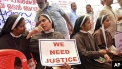 FILE - Catholic nuns hold placards demanding the arrest of a bishop who one nun has accused of rape, during a public protest in Kochi, Kerala, India, Sept. 12, 2018. 