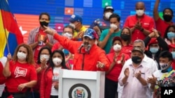 FILE - Venezuela's President Nicolas Maduro speaks to supporters during a closing campaign rally for the upcoming National Assembly elections in Caracas, Venezuela, Dec. 3, 2020. 