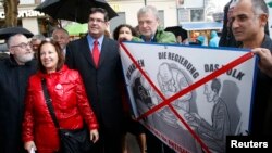 FILE - Rabbi Paul Chaim Eisenberg, left, and the president of the Jewish Community of Vienna, Oskar Deutsch, third from left, participate in a protest against anti-Semitism in Vienna, Sept. 12, 2012.