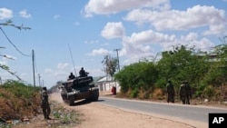 Un tanque de las fuerzas de defensa de Kenia circula por una calle frente a la universidad Garissa. 