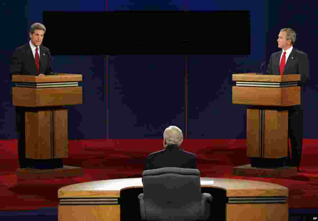 Democratic presidential candidate Sen. John Kerry answers a question as President Bush listens during the presidential debate in Tempe, Arizona, Oct. 13, 2004.