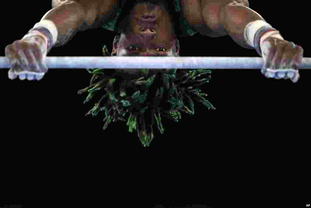 Uche Eke, of Nigeria, competes on the horizontal bar during the men's artistic gymnastic qualifications at the 2020 Summer Olympics, Saturday, July 24, 2021, in Tokyo, Japan. (AP Photo/Gregory Bull)