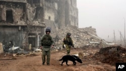 FILE - This photo made from the footage taken from Russian Defense Ministry official website on Feb. 4, 2017, claims to show Russian soldiers in a street in Aleppo, Syria. 