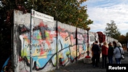 FILE - Remains of the Berlin Wall are pictured at former Bornholmer Strasse Berlin Wall border crossing point in Berlin, Germany, Oct. 18, 2019.