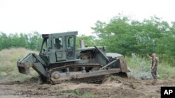 A bulldozer of the Hungarian Defense Force is used to prepare the terrain for the building of at the Hungarian-Serbian border near Morahalom, 179 kms southeast from Budapest, July 13, 2015.