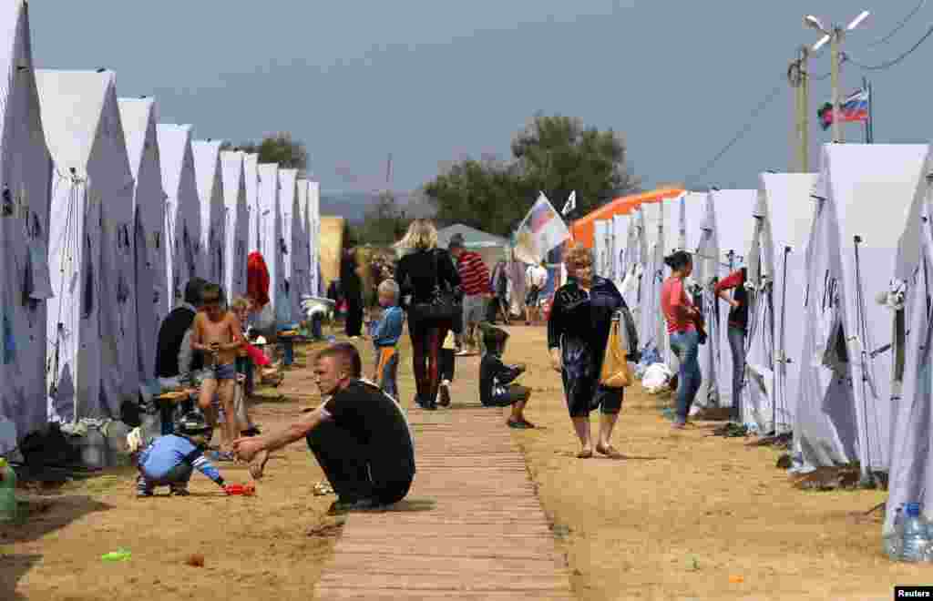 People go about their daily lives at a refugee camp set up for Ukrainians in Russia's Rostov region near the Russia-Ukraine border, Aug. 18, 2014.