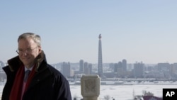 Executive Chairman of Google Eric Schmidt stands on a balcony at the Grand Peoples Study House overlooking Juche Tower in Pyongyang, North Korea, January 9, 2013.