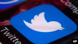 FILE - The Twitter app is seen on a mobile phone in Philadelphia, April 26, 2017.