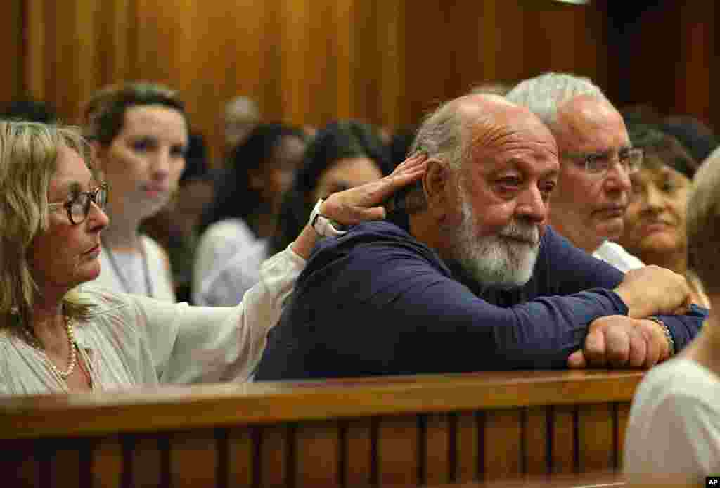 Reeva Steenkamp's father, Barry Steenkamp (right), cries while comforted by his wife as they listen to proceedings during the third day of sentencing for Oscar Pistorius, at the high court in Pretoria, South Africa, Oct. 15, 2014.