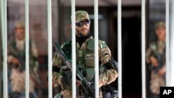 In Islamabad, Pakistani army soldiers stand guard during an emergency session of parliament, with thousands of protesters demanding the prime minister's resignation Sept. 2, 2014.