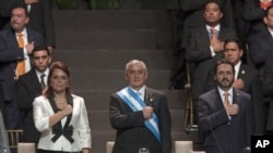 Guatemala’s President Otto Perez Molina, center, his Vice President Roxana Baldetti, left, and Congress' President Gudy Rivera listen to their national anthem during Perez's Molina and Baldetti's swearing-in ceremony in Guatemala City, January 14, 2012.