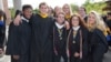 FILE -- Friends pose together at their graduation from Merrimack College in North Andover, Massachusetts. (Photo by Flickr user Merrimack College via Creative Commons license)