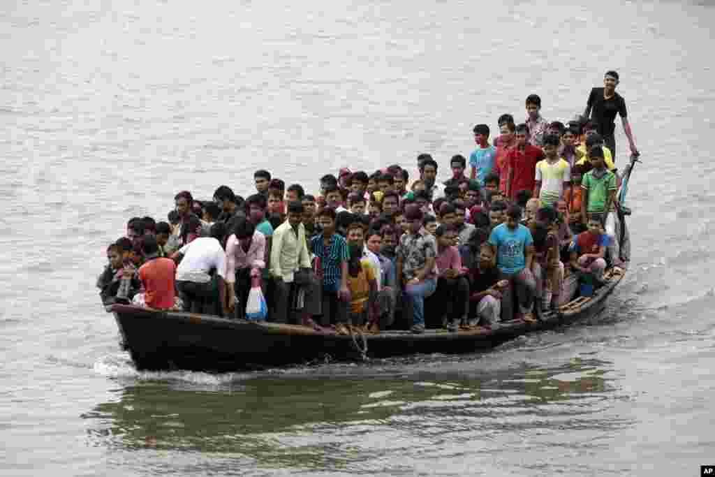 Bangladeshi people, mostly garment workers, ride an overloaded boat during a nationwide strike called by Islamic party Jamaat-e-Islami, on the outskirts of Dhaka. The strike has been called to demand the release of the party's detained president and to draw attention to other missing leaders, according to news reports.