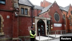 A police officer stands outside Didsbury mosque in Manchester, Britain, May 24, 2017. 