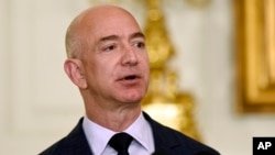 FILE - Jeff Bezos, the founder and CEO of Amazon.com, speaks in the State Dining Room of the White House in Washington. 