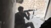 FILE - This undated file photo posted Nov. 4, 2014 by the Raqqa Media Office of the Islamic State group, a militant extremist group, shows an Islamic state group fighter in Kobani, Syria. 