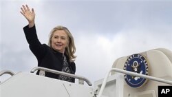 Secretary of State Hillary Rodham Clinton boards plane at Andrews Air Force Base, Md., Nov. 28, 2011.