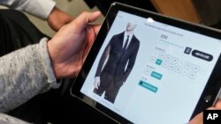 Bonobos guide Reynaldo Sanchez inputs clothing information into the store's customer website for a customer. More shoppers are spending online and demanding more personal and convenient ways to buy. 