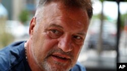 (File) This June 19, 2020 photo shows Perry Porikos owner of The Brown Jug restaurant in Ann Arbor, Mich. “If I don’t have higher capacity, I cannot make it,” he says of the coronavirus capacity limits.