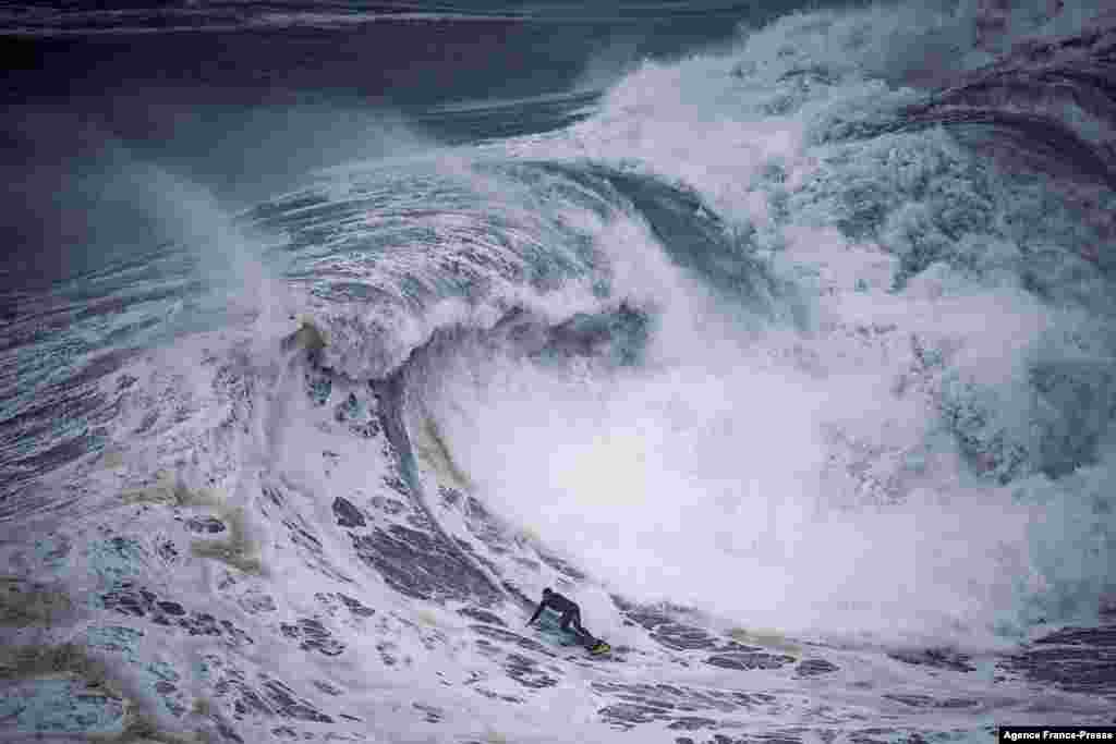 A surfer rides a wave at the Praia do Norte in Nazare, Portugal, Dec. 11, 2021.