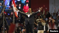 FILE - Peru's former president Alan Garcia greets supporters during a meeting in Lima, Oct. 30, 2015. 