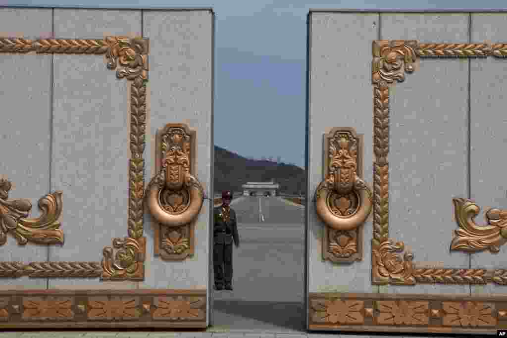 A North Korean soldier guards the entrance to Pyongyang's Kumsusan mausoleum, where the bodies of the late leaders Kim Il Sung and Kim Jong Il lie embalmed, April 15, 2013.