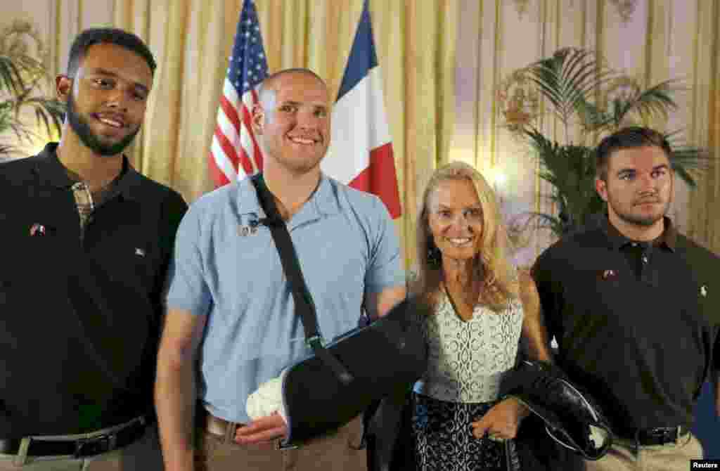 U.S. Ambassador to France Jane Hartley (2nd right) with student Anthony Sadler (far left), U.S Airman First Class Spencer Stone (2nd left) and National Guardsman Alek Skarlatos as they attend a ceremony at the U.S. embassy in Paris, Aug. 23, 2015.