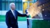 President Joe Biden touches a piece of steel from the North Tower of the World Trade Center while visiting a memorial to the September 11 terrorist attacks at NATO headquarters in Brussels, Monday, June 14, 2021. (AP Photo/Patrick Semansky)