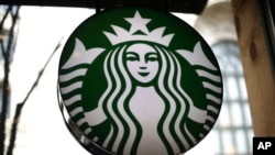 FILE - This is a sign in a Starbucks located in downtown Pittsburg, Pennsylvania, 24, 2018. Starbucks is getting rid of plastic straws at its locations around the world.