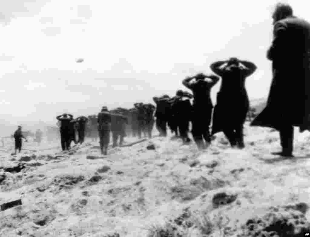 German prisoners of war are led away by Allied forces during landing operations at Utah Beach, Normandy coast, France, June 6, 1944.
