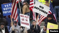 FILE - People gather to protest against the United States' acceptance of Syrian refugees at the Washington State Capitol in Olympia, Wash., Nov. 20, 2015.