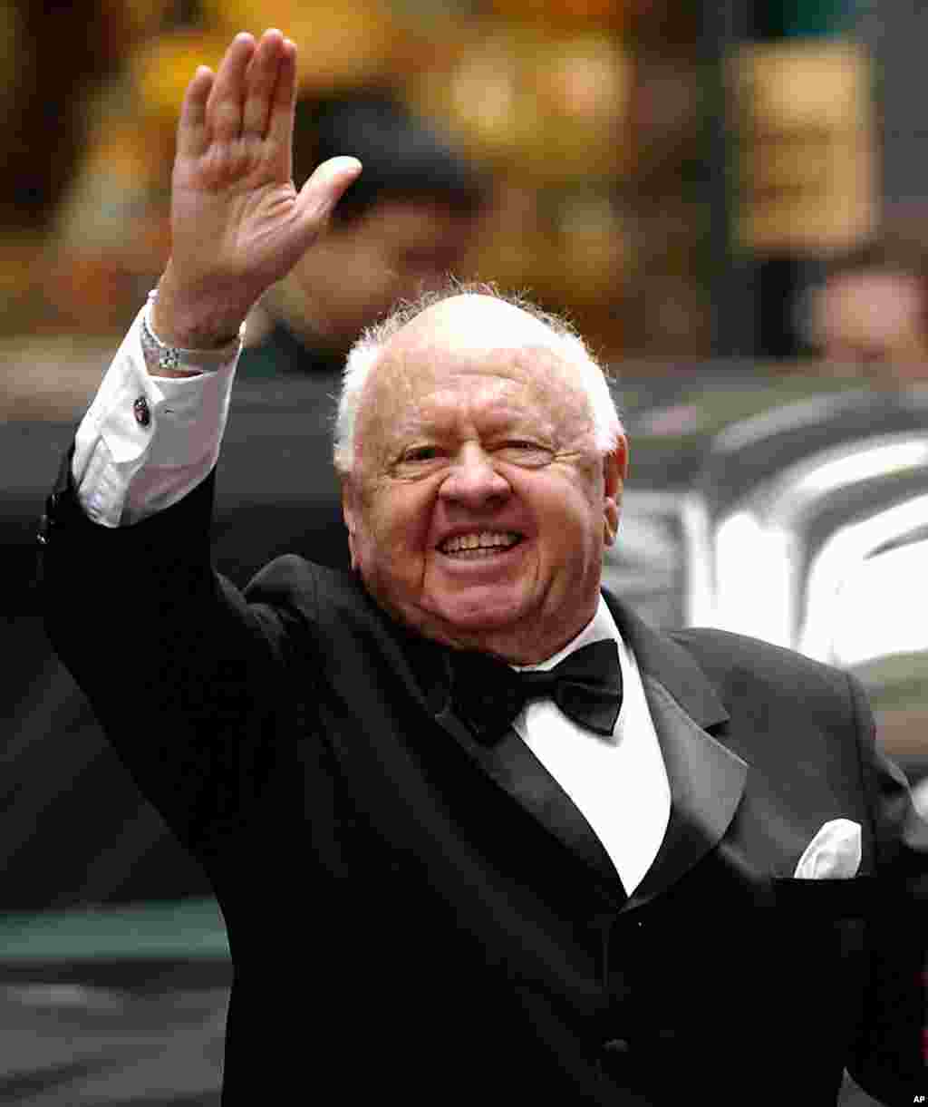 Actor Mickey Rooney waves to admirers as he departs the Regent Wall Street Hotel in New York. He was Hollywood's top box-office draw in the late 1930s-1940s. He died Sunday, April 6, 2014, at his North Hollywood home at age 93.