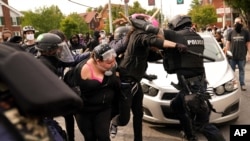 Police and protesters clash, Wednesday, Sept. 23, 2020, in Louisville, Ky. A grand jury has indicted one officer on criminal charges six months after Breonna Taylor was fatally shot by police in Kentucky. 