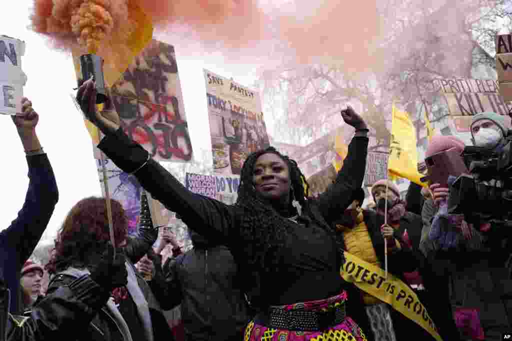 A protester holds a flare during the 'Kill the Bill' march on the national day of action in London, Jan. 15, 2022. Protesters march in London, Bristol, Coventry, Newcastle, Liverpool, Sheffield, Plymouth and more ahead of the Lords' final vote on the bill on Jan. 17.
