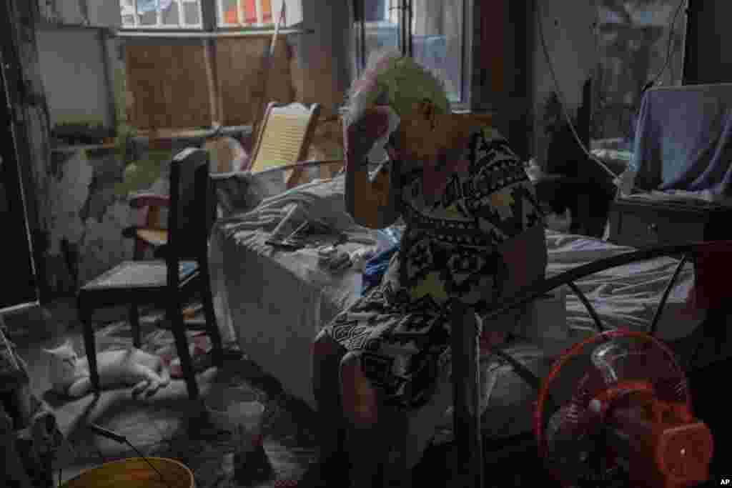 Margarita Salazar, 82, wipes the sweat off with a tissue inside her home amid high heat in Veracruz, Mexico, June 16, 2024.