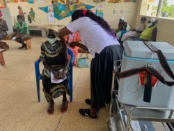 FILE - Mary Nyoka, 65, of South Sudan gets the AstraZeneca COVID-19 vaccine at Swinga Health Centre 3 in Bidibidi. settlement, Yumbe district, northern Uganda. (Halima Athumani/VOA)