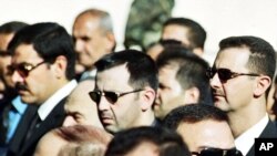 Foto del 13 de junio del 2000, en el que aparece el presidente Bashar Assad (derecha), su hermano Maher (centro) y su cuñado el general Assef Shawkat, que murió en el atentado de hoy.