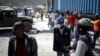 Seorang petugas dari Kementerian Kesehatan Masyarakat dan Populasi meminta seorang perempuan Haiti yang kembali dari Republik Dominika untuk menjalani tes virus corona, di Malpasse, Haiti, 5 Maret 2020. (Foto: Reuters)