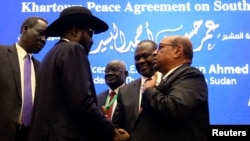 FILE - South Sudan President Salva Kiir, Sudan's President Omar al-Bashir and South Sudan rebel leader Riek Machar are seen after peace talks in Khartoum, Sudan, June 27, 2018.