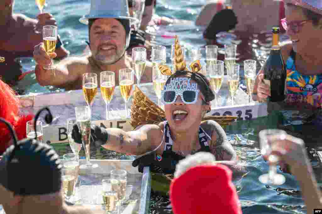 Revelers take part in a New Year's day swim in Lake Geneva with its 7.3 degree celsius waters in Geneva, Switzerland.