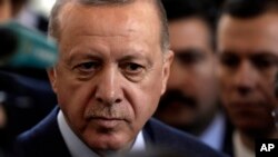 Turkish President Recep Tayyip Erdogan speaks to journalists at parliament in Ankara, Feb. 19, 2020. 