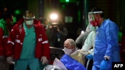 FILE - An elderly man with symptoms of the new coronavirus is transferred from the Carpe Diem nursing home to a hospital in Buenos Aires, May 07, 2020. 