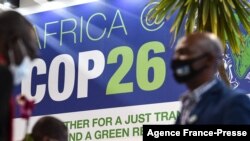FILE - People stand by the Africa pavilion at the previous COP26 U.N. Climate Change Conference in Glasgow on Nov. 2, 2021.