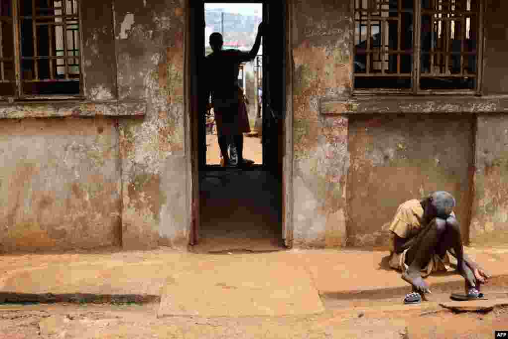 An inmate sits in the sun at the Central Prison in Freetown, Sierra Leone. According to many NGOs, prisoners have extremely hard living conditions and have suffered for years from a lack of access to food and water.