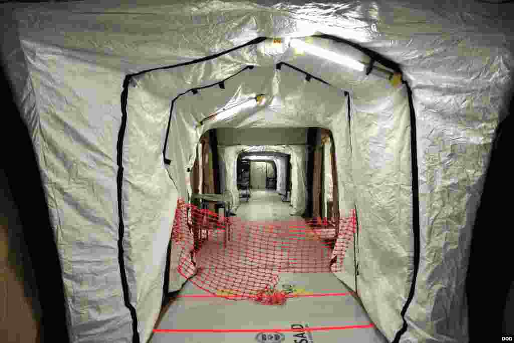 Simple red lines on the floor are what mark the boundary between the low-risk zone and the high-risk zone inside the Monrovia Medical Unit, near Monrovia, Liberia, Nov. 4, 2014. (Sgt. 1st Class Nathan Hoskins/DOD)