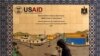 A Palestinian walks past a ceramic sign of a U.S. Agency for International Development (USAID) project in Hebron in the Israeli-occupied West Bank, Jan. 31, 2019.